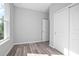 Spacious bedroom with gray walls, wood-look floors, and a large window at 765 6Th Ave, Osteen, FL 32764