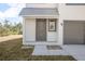 Modern gray front door with a sidelight window and small porch at 765 6Th Ave, Osteen, FL 32764