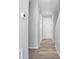 Bright hallway with gray walls, wood-look floors, and white interior door at 765 6Th Ave, Osteen, FL 32764