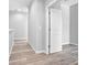 Hallway with wood-look floors and doors to rooms at 765 6Th Ave, Osteen, FL 32764