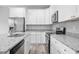 Modern kitchen with white cabinets, granite countertops, and stainless steel appliances at 765 6Th Ave, Osteen, FL 32764