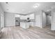 Open concept kitchen with island, stainless steel appliances, and wood-look flooring at 765 6Th Ave, Osteen, FL 32764