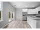 Open concept kitchen with island and sliding glass doors to patio at 765 6Th Ave, Osteen, FL 32764