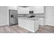 Modern kitchen with island, white cabinets, granite countertops, and stainless steel appliances at 765 6Th Ave, Osteen, FL 32764