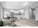 Open living room and kitchen area with wood-look floors at 765 6Th Ave, Osteen, FL 32764