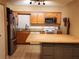 Another view of the modern kitchen with wood cabinets and an island at 849 Orange Oak Dr, Orange City, FL 32763