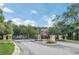 Gated community entrance with lush landscaping and signage at 446 Penny Royal Pl, Oviedo, FL 32765