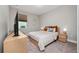 Bedroom with striped bedding, wood-look dresser, and TV at 11209 Lemon Lake Blvd, Orlando, FL 32836