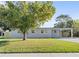 Newly renovated home with gray exterior, carport, and fenced yard at 1125 Murdock Blvd, Orlando, FL 32825