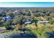 Aerial view of a lakefront home, showcasing the property and surrounding neighborhood at 1405 Spring Lake Ter, Ocoee, FL 34761