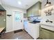 Bright laundry room, features stylish cabinets, farmhouse sink, and modern appliances at 1405 Spring Lake Ter, Ocoee, FL 34761