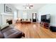 Living room with hardwood floors, fireplace, and flat-screen TV at 1406 S Osceola Ave, Orlando, FL 32806