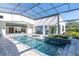 Luxury pool and spa with covered patio, dolphin mural, and relaxing seating at 1410 Shady Meadow Ln, Deland, FL 32724