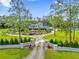 Aerial view showcasing the castle-like home, expansive lawn, and circular driveway at 14502 Scotch Pine Ct, Orlando, FL 32832