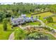 Aerial view of a castle-like home with a pond and lush landscaping at 14502 Scotch Pine Ct, Orlando, FL 32832