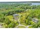 Aerial view of a storybook castle on a large lot with a pond at 14502 Scotch Pine Ct, Orlando, FL 32832