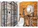 Bathroom with a walk-in shower, a rustic vanity, and wood walls at 14502 Scotch Pine Ct, Orlando, FL 32832