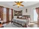Guest bedroom with a ceiling fan, large windows, and a door to the outside at 14502 Scotch Pine Ct, Orlando, FL 32832