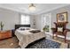 Bedroom with a king-size bed, a leather armchair, and a blue area rug at 14502 Scotch Pine Ct, Orlando, FL 32832