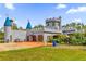 Fairytale castle-style home with a three-car garage and manicured lawn at 14502 Scotch Pine Ct, Orlando, FL 32832