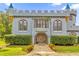 Exterior view of a charming castle-styled home with stone facade and detailed entrance at 14502 Scotch Pine Ct, Orlando, FL 32832