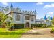 Fairytale castle exterior featuring a unique design, lush landscaping, and a paved driveway at 14502 Scotch Pine Ct, Orlando, FL 32832