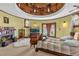 Round main bedroom with fireplace, circular balcony, and large windows at 14502 Scotch Pine Ct, Orlando, FL 32832