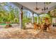 Relaxing patio with pool view, stone pavers, and unique wooden furniture at 14502 Scotch Pine Ct, Orlando, FL 32832