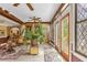Sunroom with large windows, exposed beams, and a comfortable sitting area at 14502 Scotch Pine Ct, Orlando, FL 32832