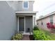 Inviting front entrance with a dark gray door and well-maintained landscaping at 1547 Scrub Jay Ct, Deland, FL 32724