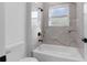 Simple bathroom with a shower/tub combo, and marble-look tile at 17064 Sw 44Th Cir, Ocala, FL 34473