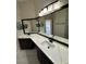 Modern bathroom with double vanity, updated fixtures, and view of pool at 2129 Bridgeview Cir, Orlando, FL 32824