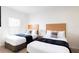 Two twin beds in a well-lit bedroom at 2604 Roadster Ln, Kissimmee, FL 34746