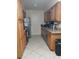 Bright kitchen featuring wood cabinets, stainless steel dishwasher, and tile floors at 2902 Calumet Dr, Orlando, FL 32810