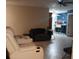 Living room with white reclining sofas and tile flooring at 2902 Calumet Dr, Orlando, FL 32810