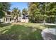 Spacious backyard with deck, grass, and palm trees at 300 Spring Run Cir, Longwood, FL 32779