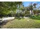 Backyard with lush greenery, palm trees, and garden at 300 Spring Run Cir, Longwood, FL 32779
