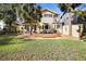 Spacious backyard with deck, grass, and palm trees at 300 Spring Run Cir, Longwood, FL 32779