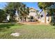 Spacious backyard with deck, grass, and palm trees at 300 Spring Run Cir, Longwood, FL 32779