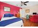 Bedroom with hardwood floors, red accent wall, and ample space at 300 Spring Run Cir, Longwood, FL 32779