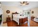 Spacious main bedroom with hardwood floors, a large bed, and fireplace at 300 Spring Run Cir, Longwood, FL 32779