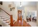Entryway with hardwood floors, wooden staircase, and a sitting area with two chairs at 300 Spring Run Cir, Longwood, FL 32779