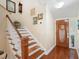 Elegant entryway with hardwood floors, a wooden staircase, and decorative artwork at 300 Spring Run Cir, Longwood, FL 32779