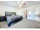 Main bedroom with ceiling fan, large bed, and walk-in closet at 40501 W 5Th Ave, Umatilla, FL 32784