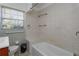 Clean bathroom with built-in bathtub and tiled walls at 4272 Kendrick Rd, Orlando, FL 32804