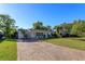 Brick paved driveway leading to a charming ranch home with a well-manicured lawn at 4272 Kendrick Rd, Orlando, FL 32804