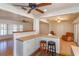 Kitchen with breakfast bar, stainless steel appliances, and view of living room at 4272 Kendrick Rd, Orlando, FL 32804