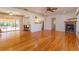 Spacious living room featuring hardwood floors, a fireplace, and access to the kitchen at 4272 Kendrick Rd, Orlando, FL 32804