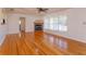 Hardwood floor living room with a fireplace and view to kitchen and hallway at 4272 Kendrick Rd, Orlando, FL 32804
