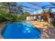Inviting kidney shaped swimming pool with screened enclosure at 4272 Kendrick Rd, Orlando, FL 32804